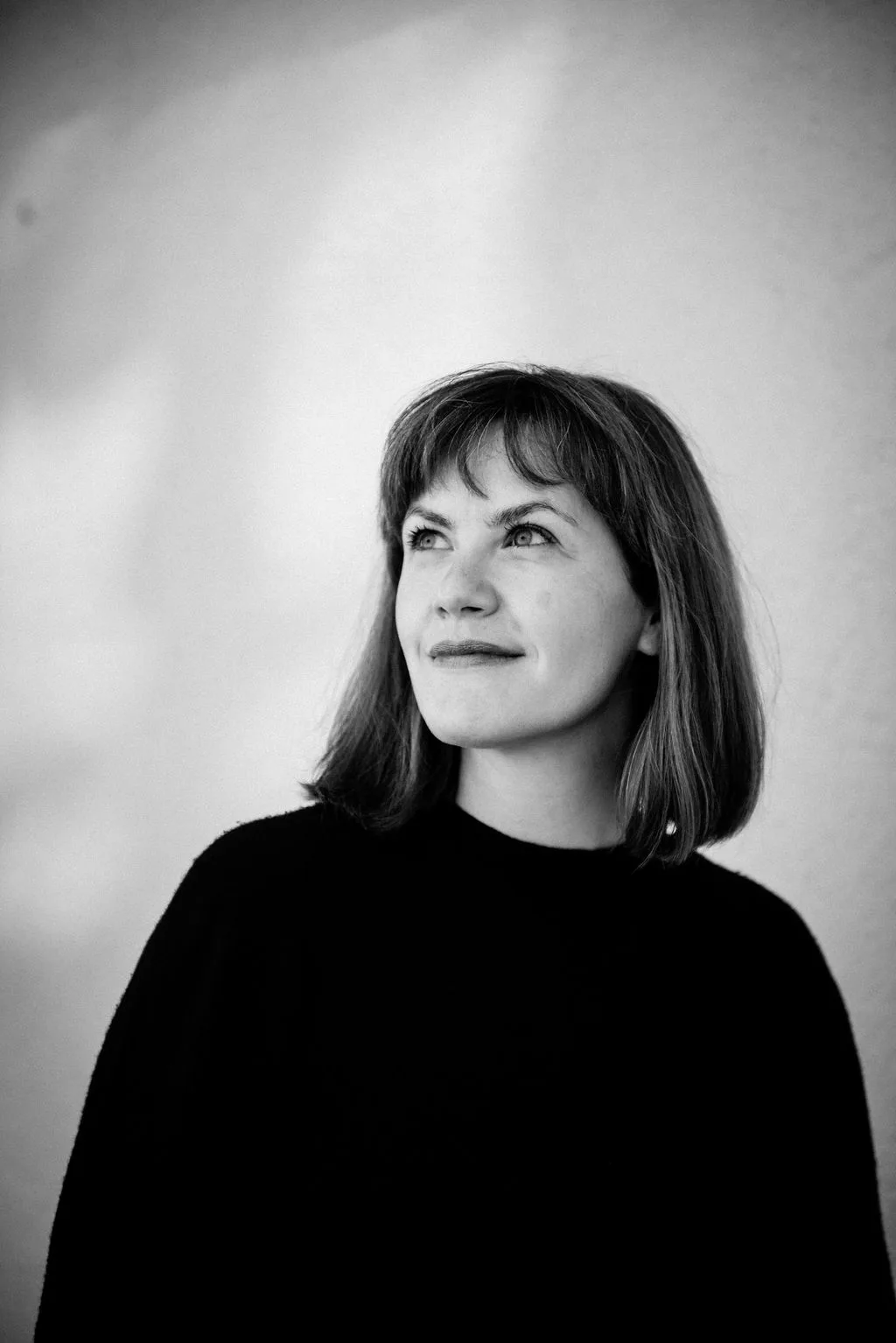 Lena Hopp looking upward in black and white portrait