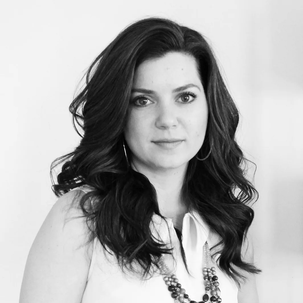 Black and white professional portrait of Lucinda Gibbons with long dark hair